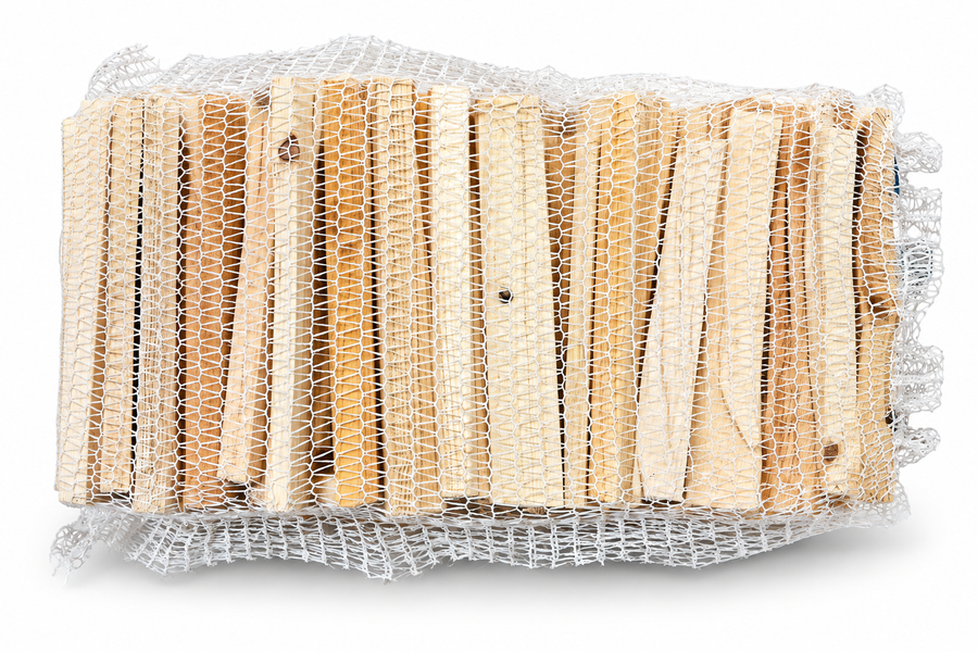 Kindling net lying on its side, showing rows of split wood sticks through white mesh
